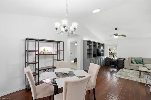 a kitchen with stainless steel appliances granite countertop a sink a stove and a wooden floors