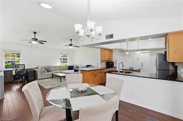 a view of a dining room with furniture wooden floor and chandelier