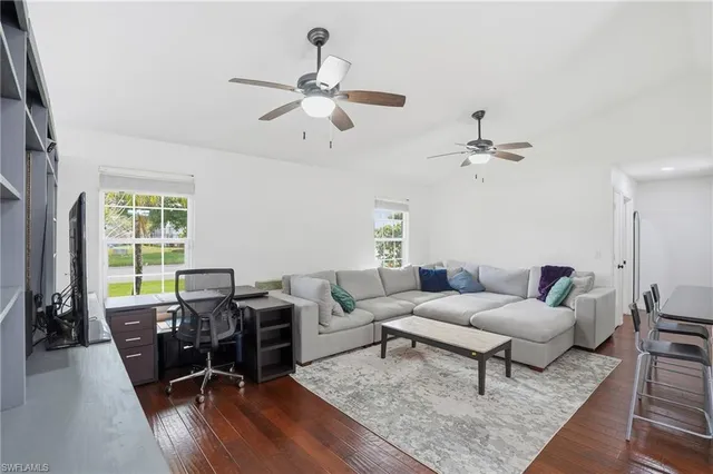 a dining room with furniture a chandelier and window