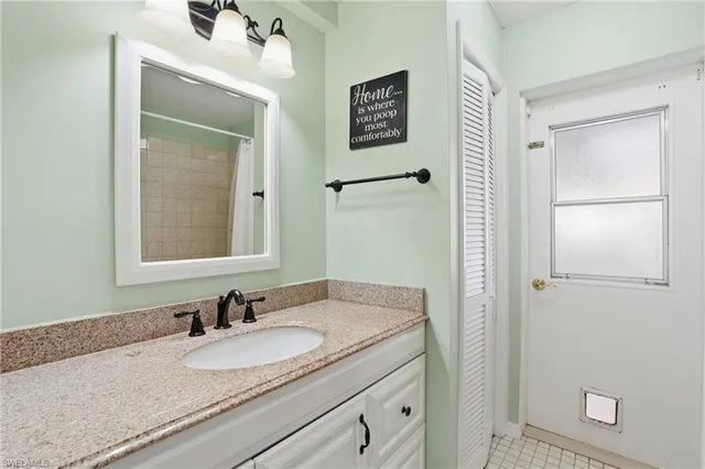 a bedroom with a bed and a ceiling fan