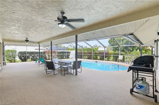 a view of a patio with a table chairs and a backyard