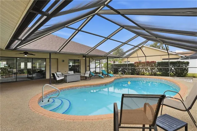 a outdoor view with a swimming pool and sitting space