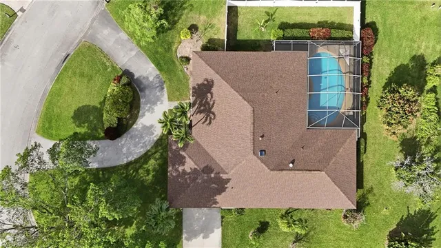 an aerial view of a house with yard and outdoor seating