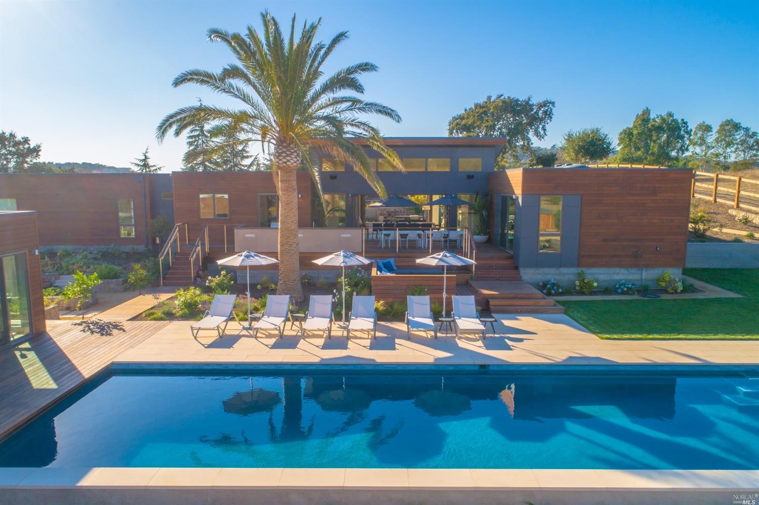 a view of swimming pool with outdoor seating and yard