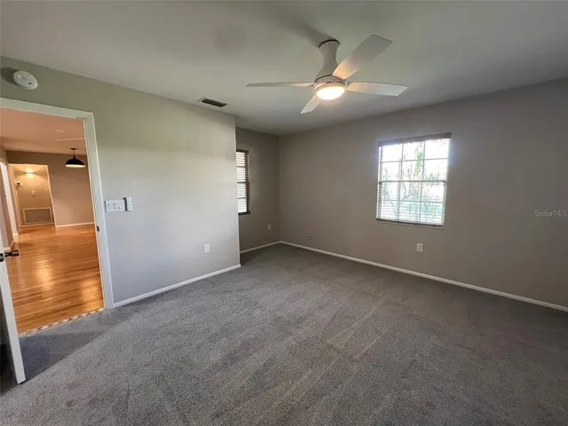 an empty room with a empty space and windows