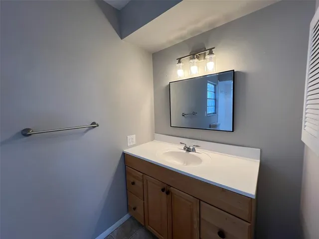 an empty room with closet and windows