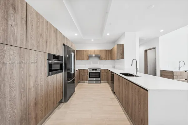 a kitchen with stainless steel appliances a refrigerator and a sink