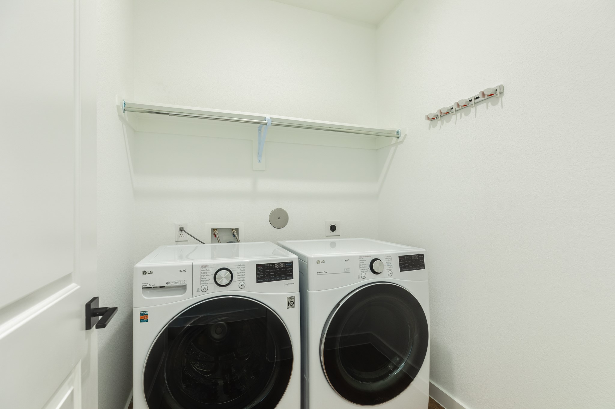 3806 Shackleton Court Rosharon, TX 77583 - Photo 13 of 50 Spacious laundry room featuring a washer and dryer, ample storage space, and a convenient clothes rack.