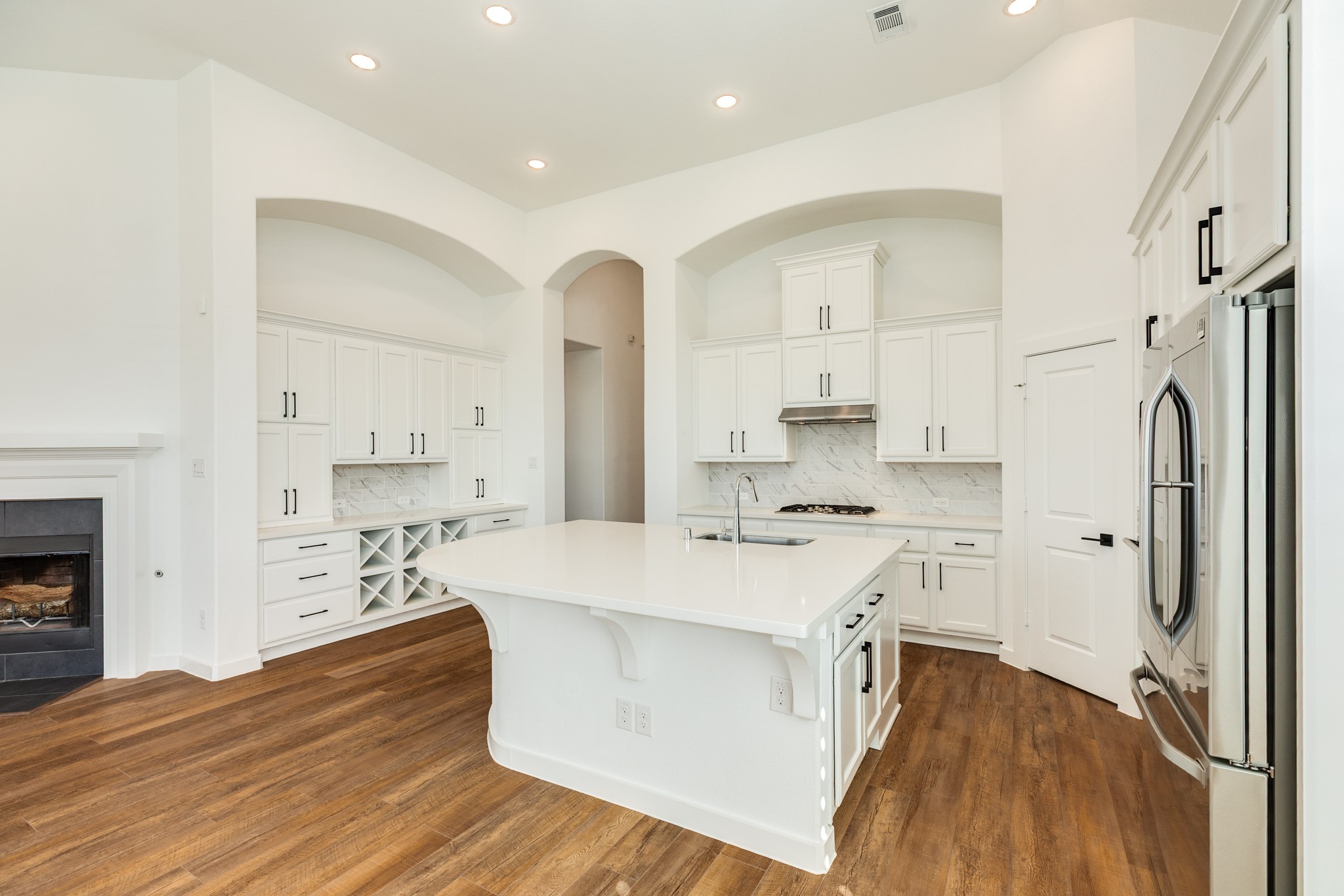 3806 Shackleton Court Rosharon, TX 77583 - Photo 15 of 50 The kitchen features a butler's pantry on the left side. Additionally, there is ample storage space located under the kitchen island, along with a large pantry.