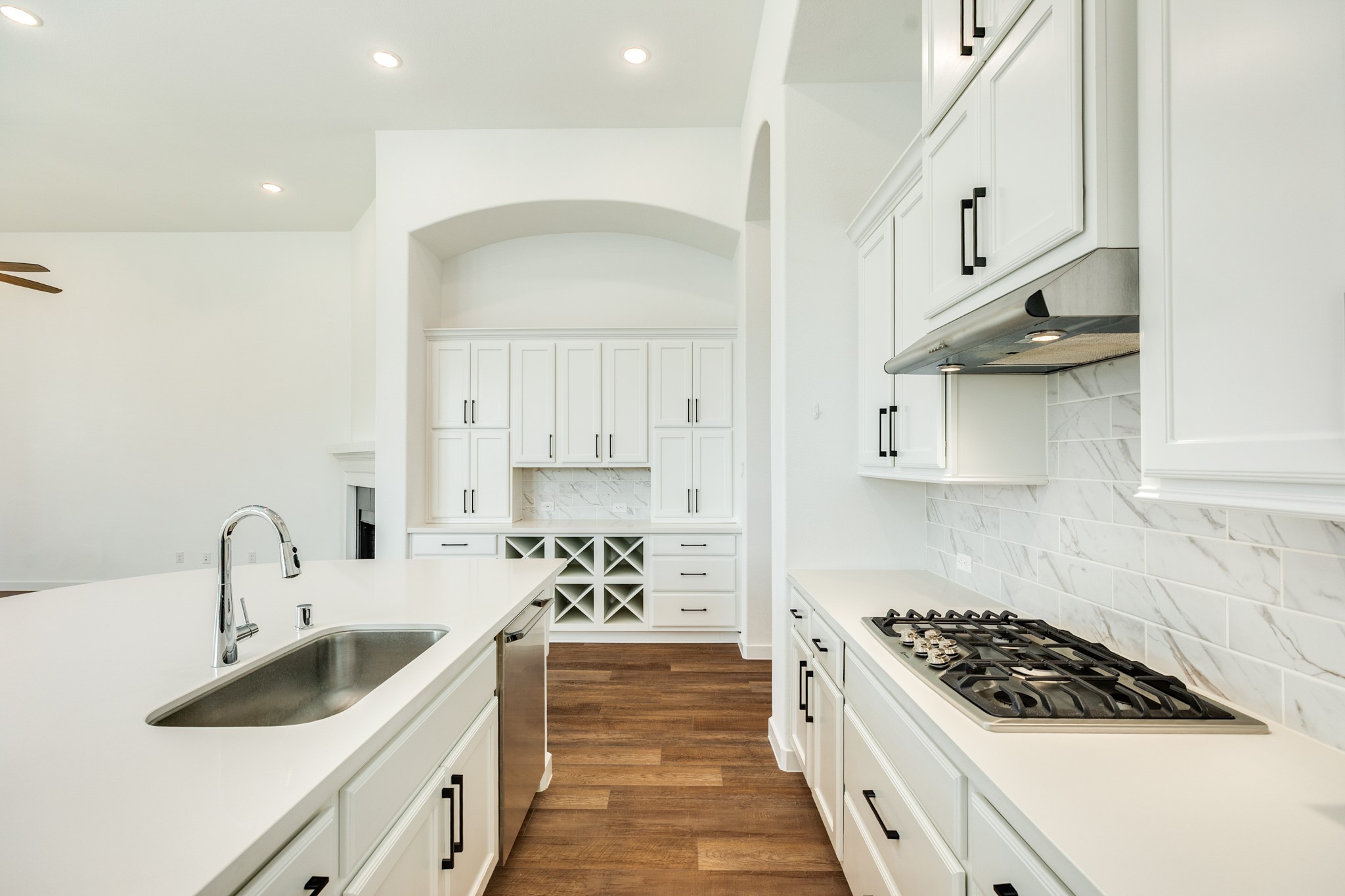 3806 Shackleton Court Rosharon, TX 77583 - Photo 18 of 50 The kitchen boasts stunning quartz countertops, complemented by black hardware and stainless steel appliances.