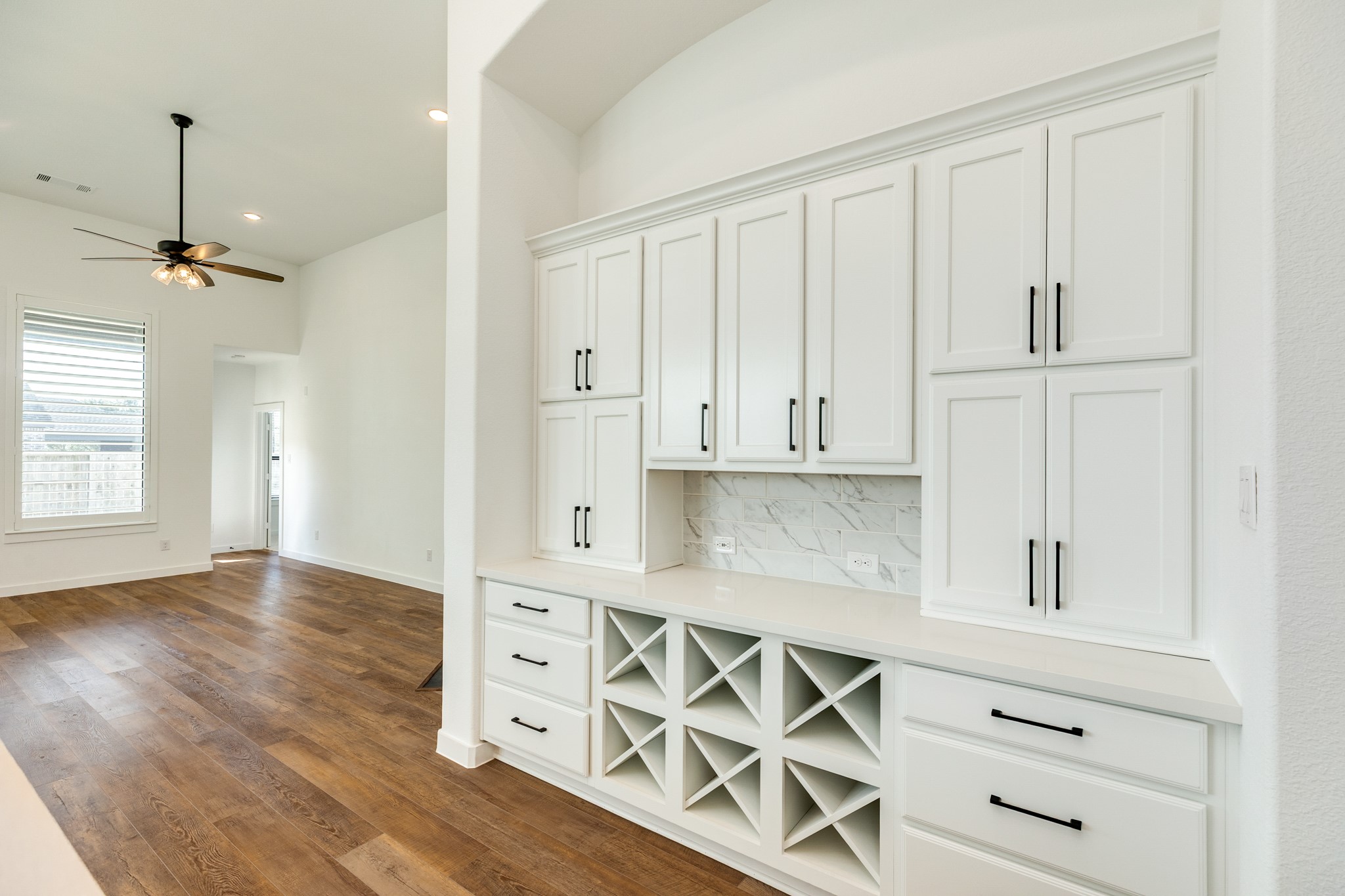 3806 Shackleton Court Rosharon, TX 77583 - Photo 48 of 50 The butler's pantry is a great addition to this floor plan, offering ample storage space. It features wine racks, a backsplash that complements the kitchen, and stylish black hardware.