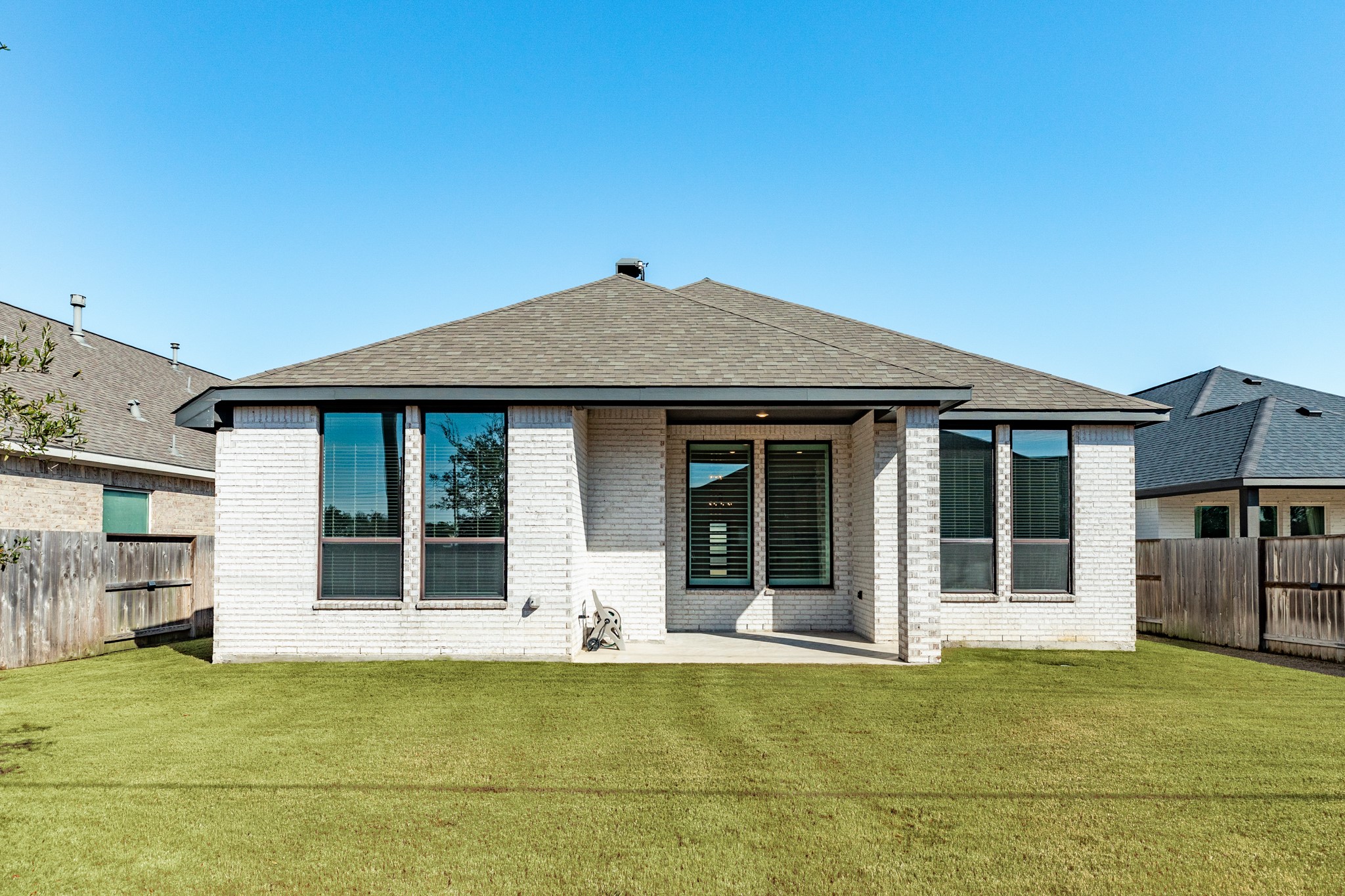 3806 Shackleton Court Rosharon, TX 77583 - Photo 2 of 50 The rear of the home features a covered patio, complemented by a wall of windows, allowing for abundant natural light.