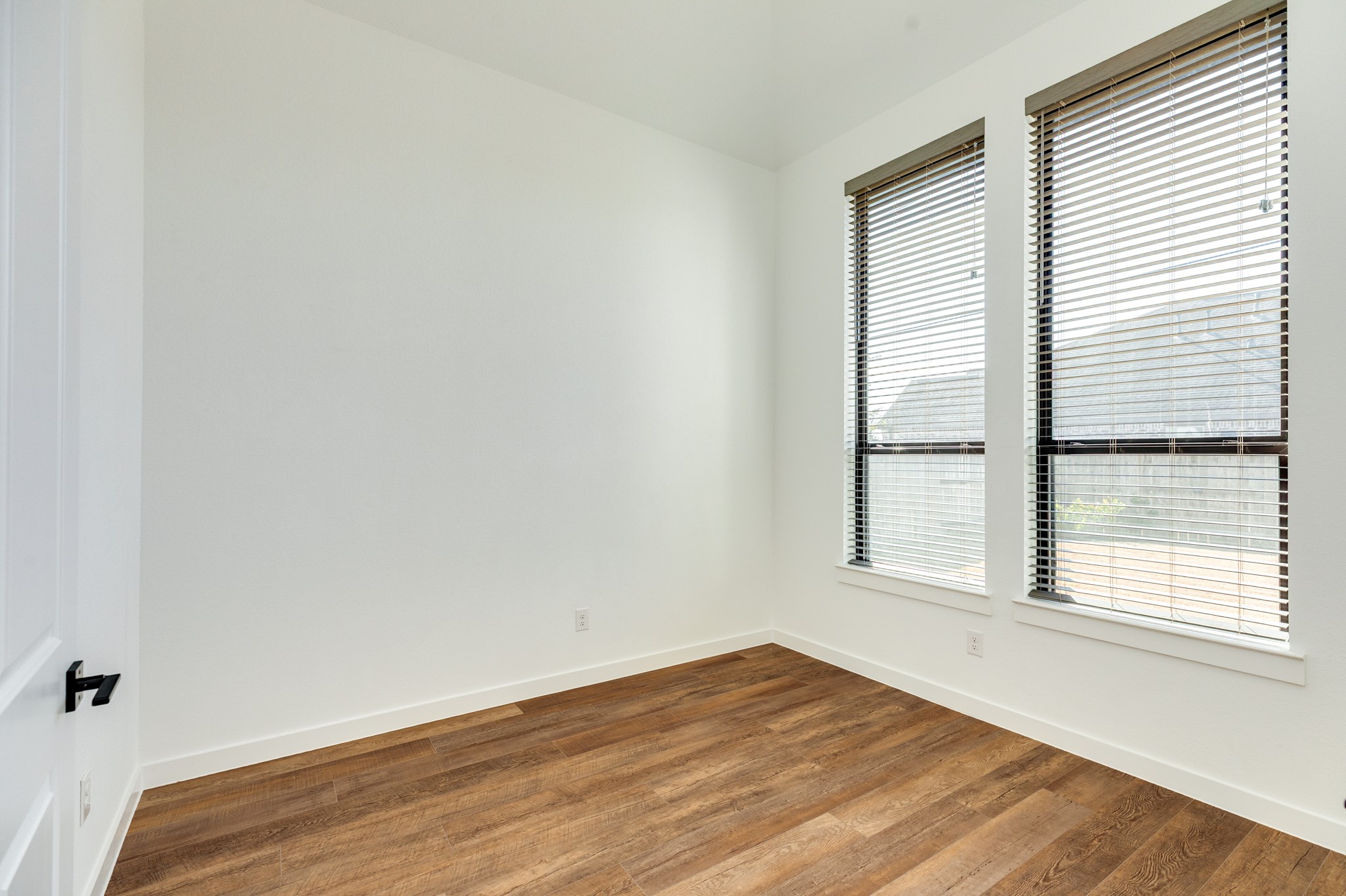 3806 Shackleton Court Rosharon, TX 77583 - Photo 22 of 50 The office features large windows offering views of the side yard, ensuring abundant natural light for the work-from-home space. Double doors provide excellent privacy.