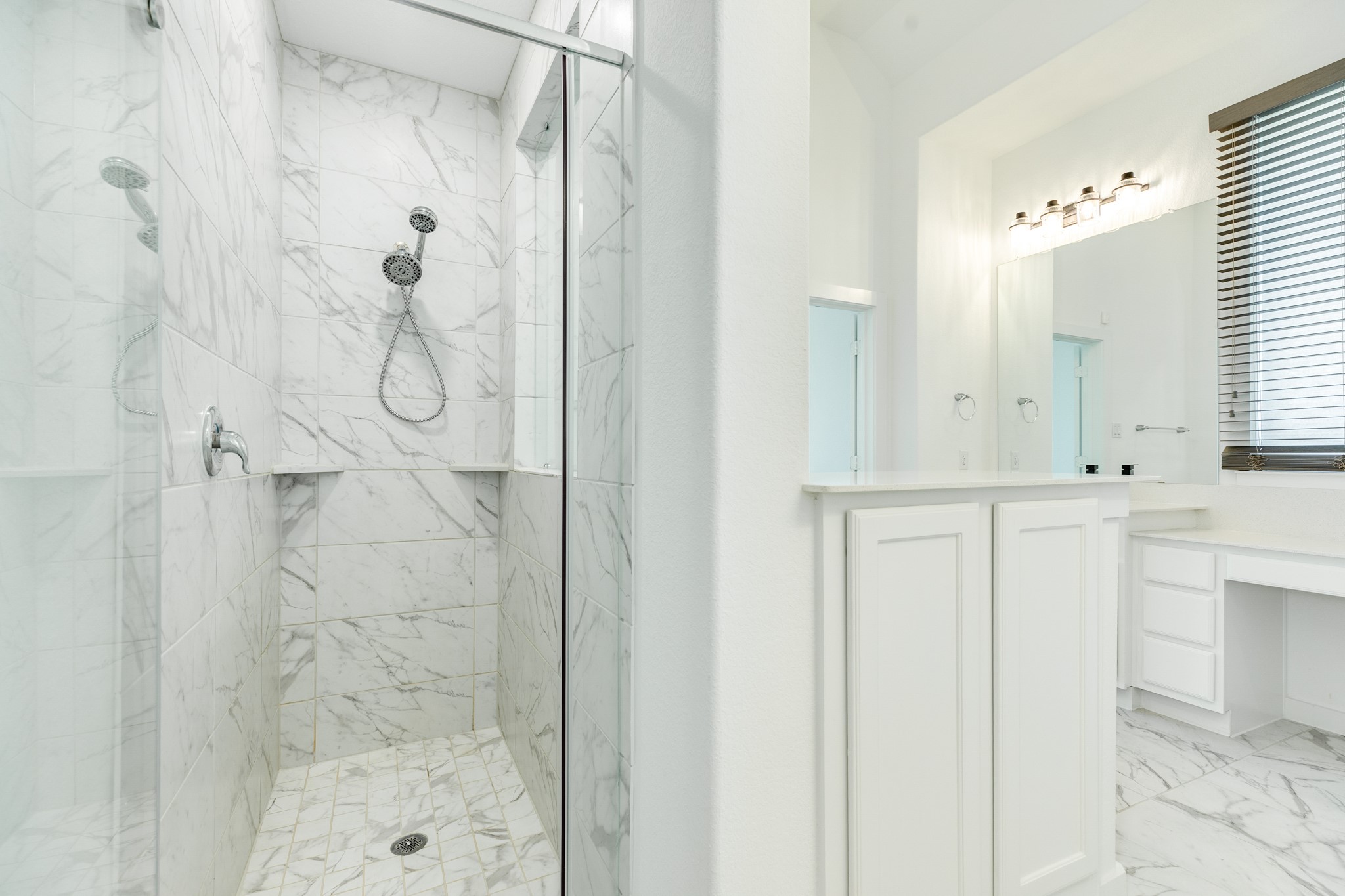 3806 Shackleton Court Rosharon, TX 77583 - Photo 29 of 50 The glass walk-in shower features matching tile and small shelves for convenient storage of personal items. A storage area is also located at the entrance on the right.