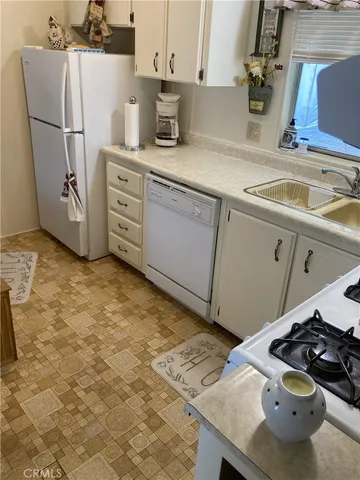a kitchen with a sink stove and refrigerator