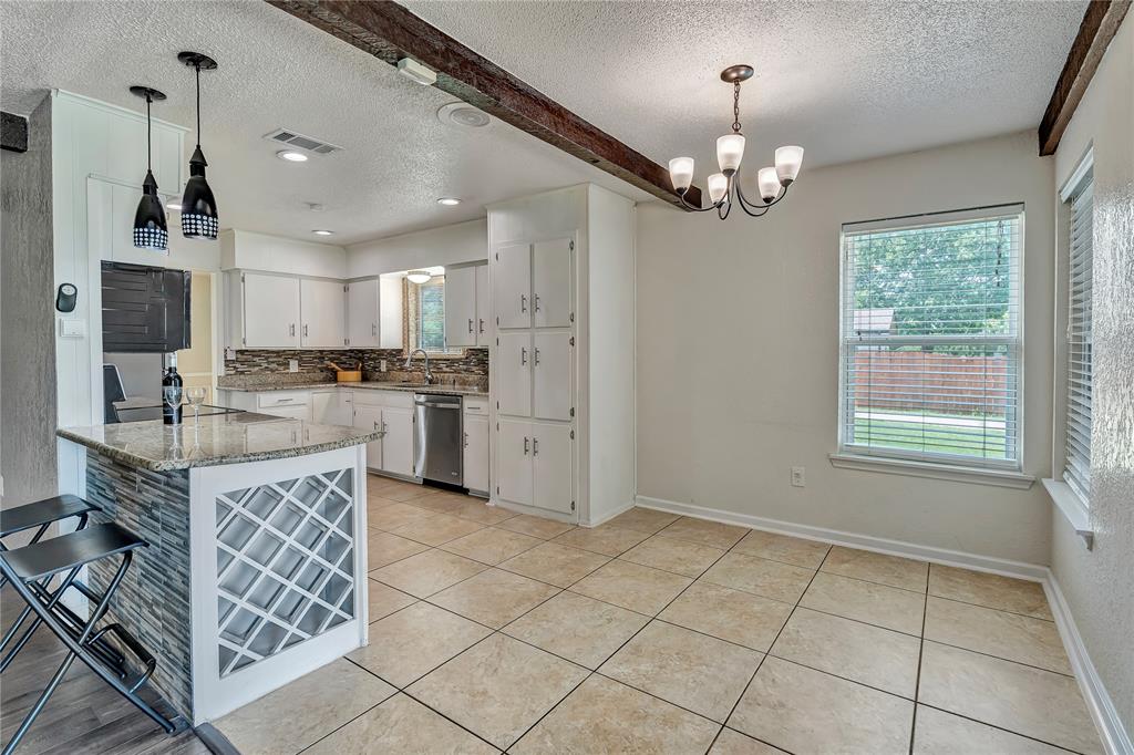 4405 Ray White Road Fort Worth, TX 76244 - Photo 10 of 36 a large kitchen with kitchen island granite countertop a stove oven and a sink with granite countertops