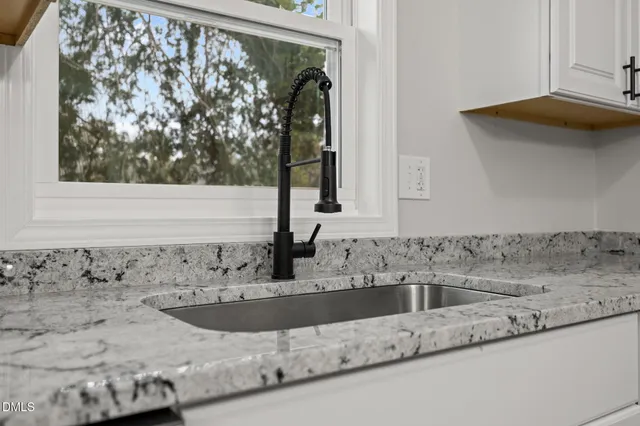 a kitchen with stainless steel appliances a stove a microwave and a hard wood floor