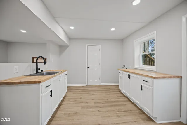 a room with painting on the wall and a window