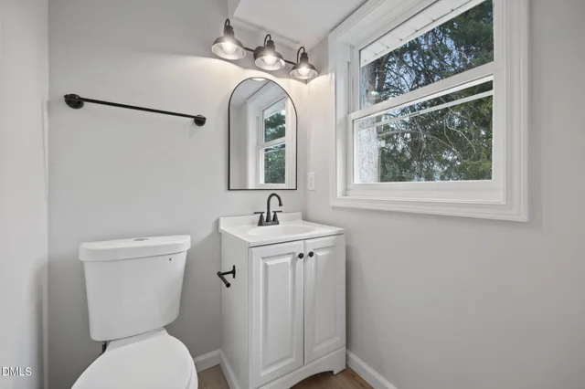 an empty room with a ceiling fan and a view of a livingroom