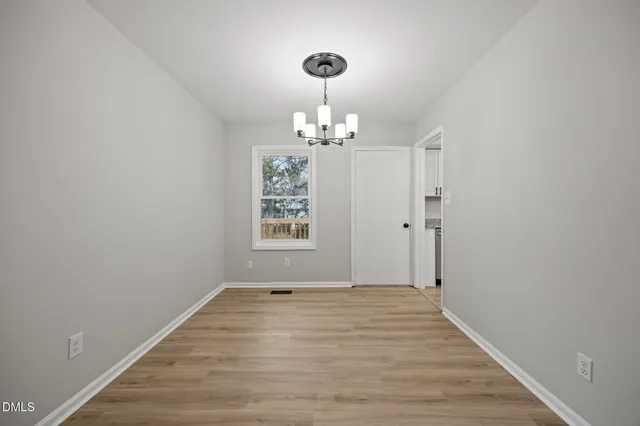 a view of a room with wooden floor