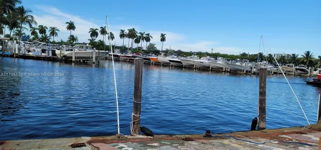 a view of a lake with boats and trees in the background