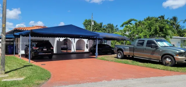 a view of a car park in front of house