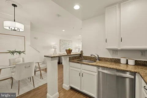 a kitchen with a sink cabinets and window