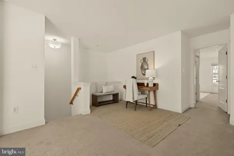 a view of a livingroom with furniture and a window