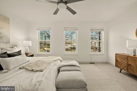 a bedroom with a bed and glass window