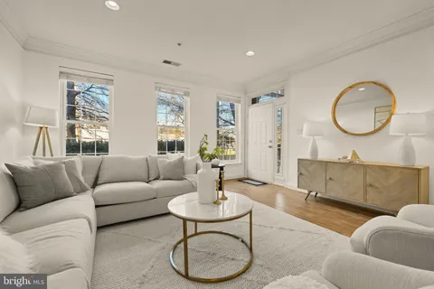 a living room with furniture a table and a large window
