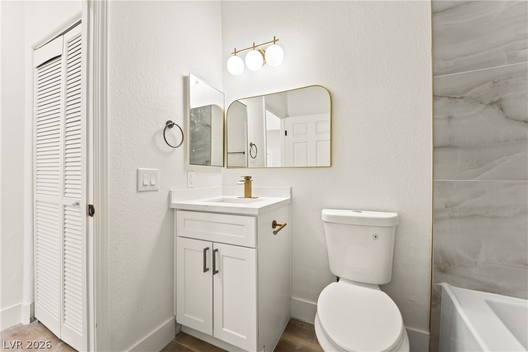 4730 East Craig Road, Unit 1053 Las Vegas, NV 89115 - Photo 11 of 32 A well-appointed bathroom boasts a modern vanity with a sleek golden faucet and an elegant wall-mounted mirror.