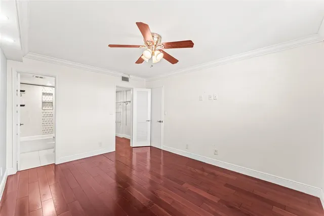 a view of a room with wooden floor and white walls