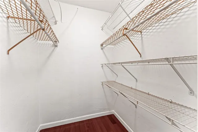 a view of a balcony with floor to ceiling windows with wooden floor