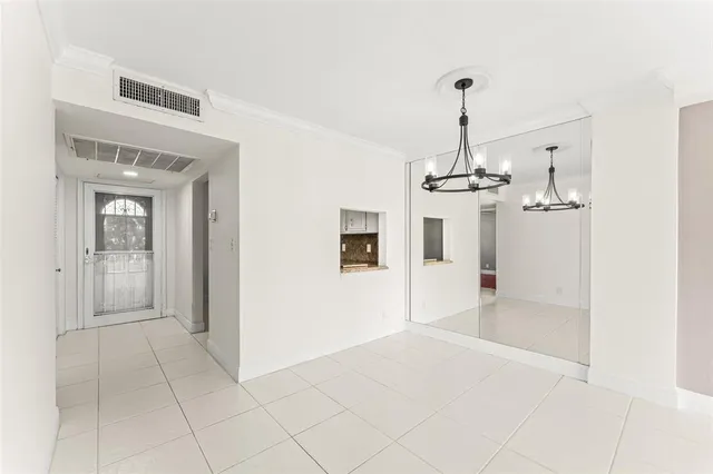 a view of a hallway with a chandelier
