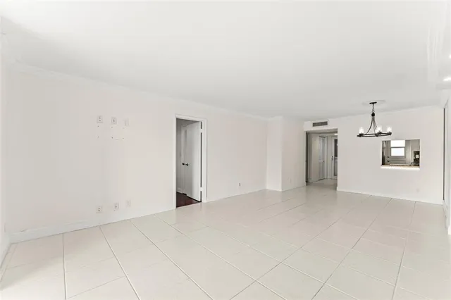 a view of a big room with wooden floor and windows in a room