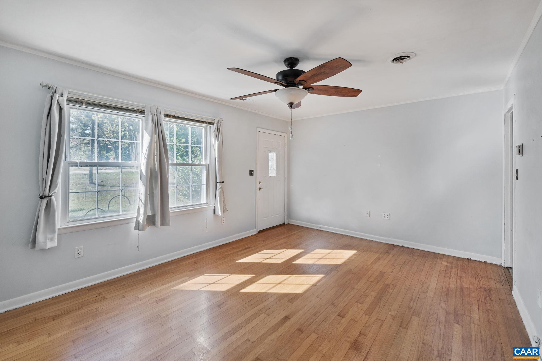 2380 South Constitution Route Dillwyn, VA 23936 - Photo 4 of 41 an empty room with wooden floor fan and windows