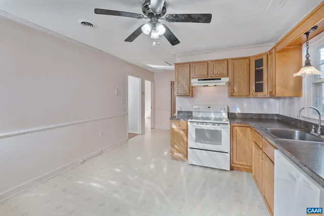 a kitchen with a stove cabinets and a refrigerator