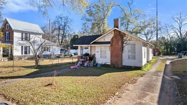 a view of a house with a yard covered in snow