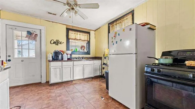 a kitchen with a refrigerator and a stove