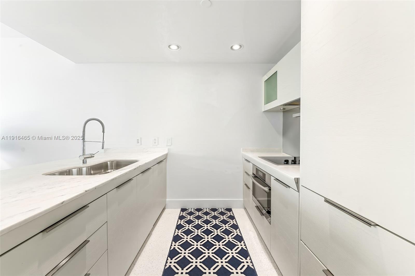 200 Biscayne Blvd Way, Unit 4005 Miami, FL 33131 - Photo 4 of 17 a kitchen with a sink and a stove