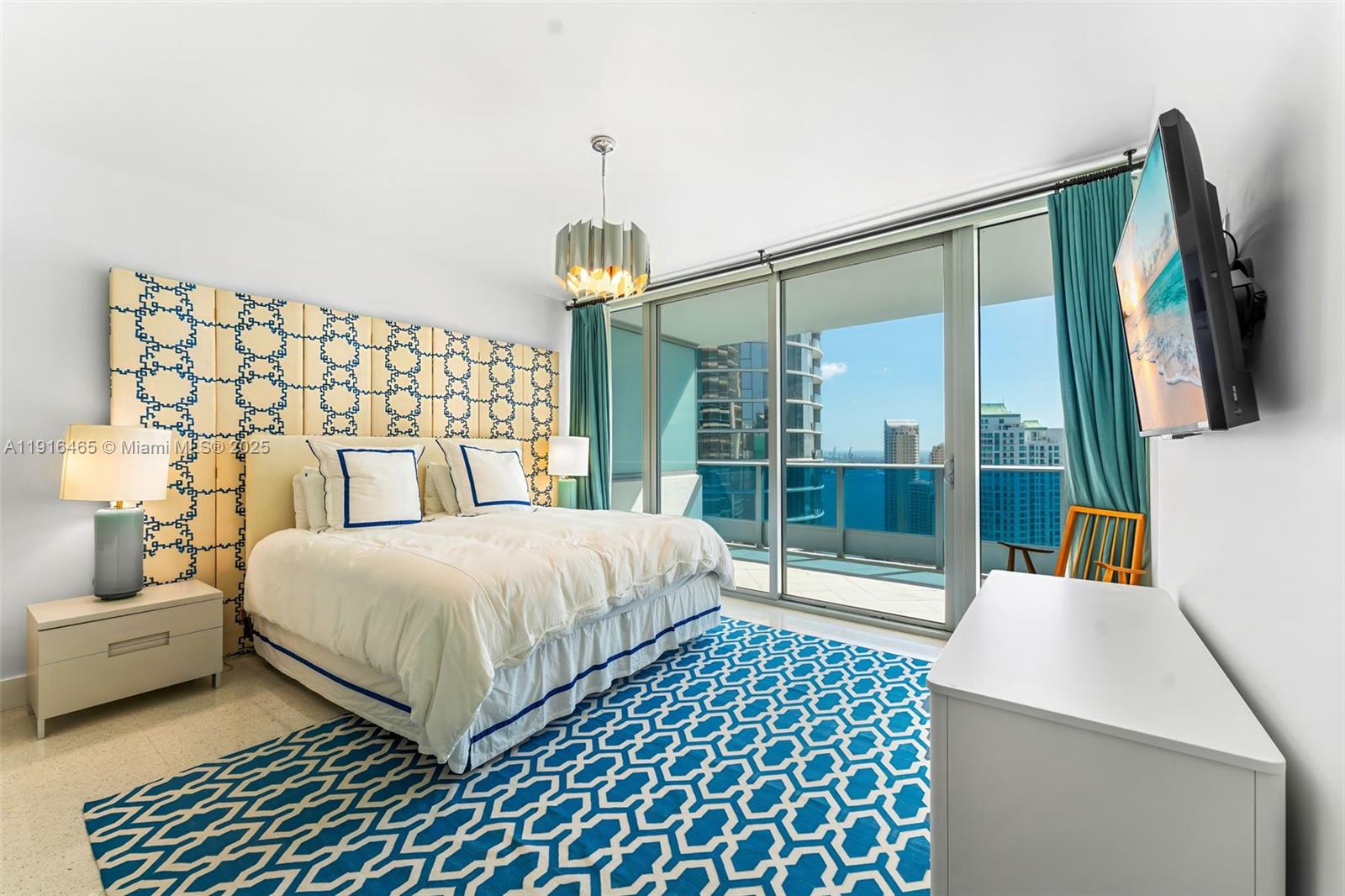 200 Biscayne Blvd Way, Unit 4005 Miami, FL 33131 - Photo 6 of 17 a bedroom with a large bed and a flat tv screen next to a lamp