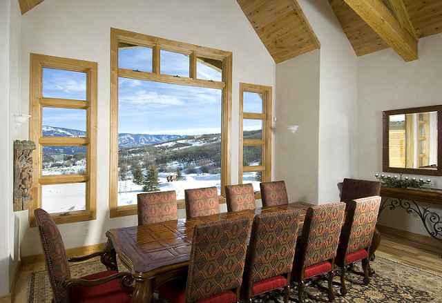 805 Sopris Mountain Ranch Road Basalt, CO 81621 - Photo 11 of 23 a view of a dining room with furniture large windows and wooden floor