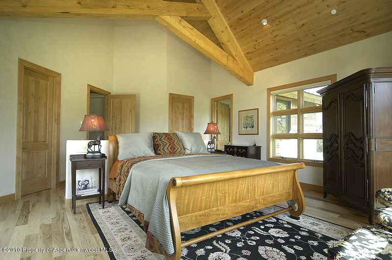 805 Sopris Mountain Ranch Road Basalt, CO 81621 - Photo 13 of 23 a bedroom with a bed and wooden floor