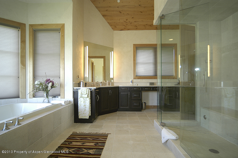 805 Sopris Mountain Ranch Road Basalt, CO 81621 - Photo 14 of 23 a bathroom with a granite countertop sink mirror and shower