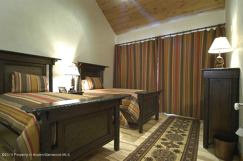 805 Sopris Mountain Ranch Road Basalt, CO 81621 - Photo 15 of 23 a room with a bed and a table