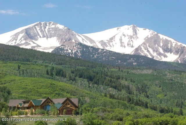 805 Sopris Mountain Ranch Road Basalt, CO 81621 - Photo 8 of 23 a view of a big house with a big yard and large trees