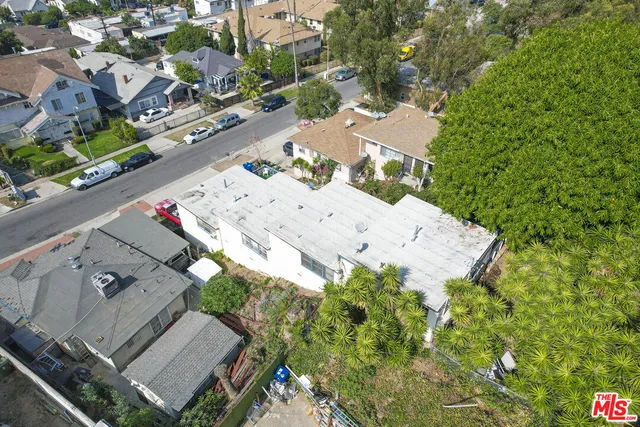 an aerial view of a house with a yard