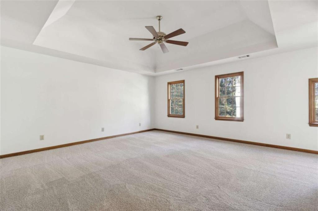 3083 Callie Still Road Lawrenceville, GA 30045 - Photo 38 of 73 an empty room with windows and fan