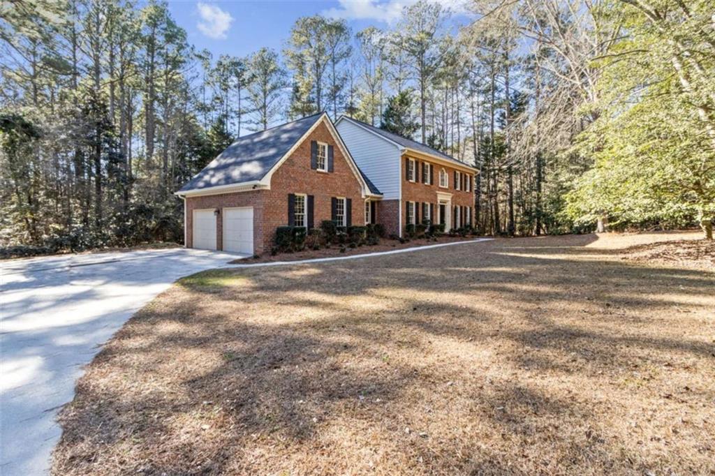 3083 Callie Still Road Lawrenceville, GA 30045 - Photo 4 of 73 a front view of a house with a yard