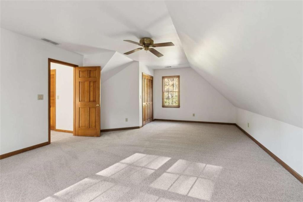 3083 Callie Still Road Lawrenceville, GA 30045 - Photo 53 of 73 an empty room with windows and fan